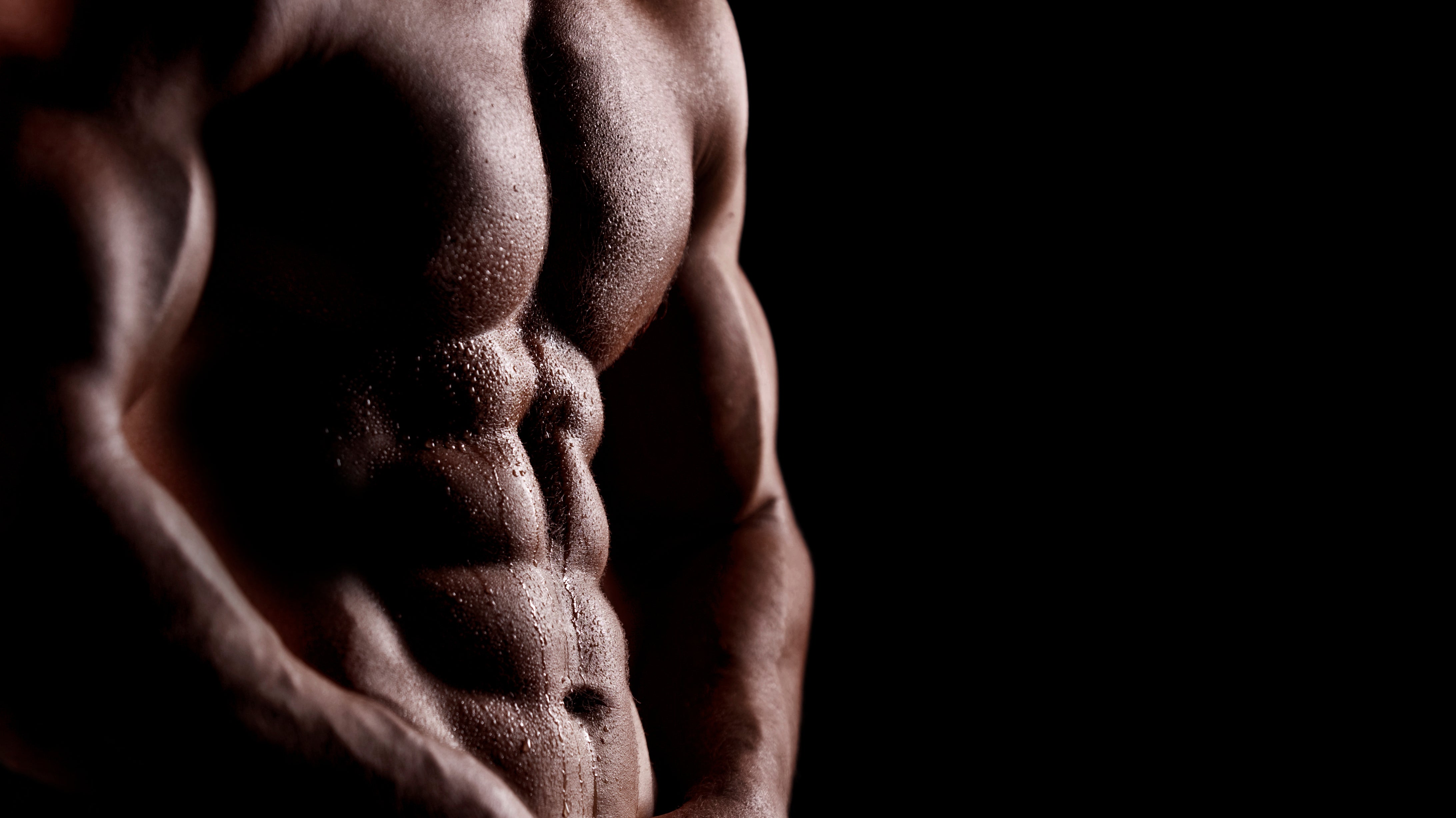 Man in the picture is showing his muscle definition and how it can be possible to tone muscle with BJJ