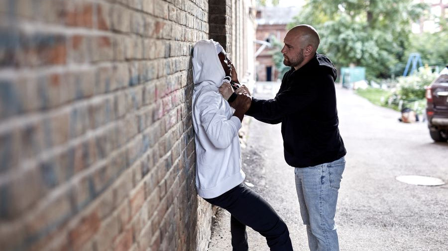 Man and woman in a street altercation.