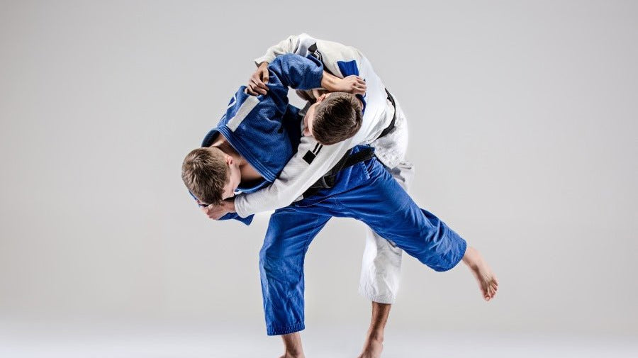 2 BJJ experts performing BJJ takedown technique at home infront of a greenscreen.