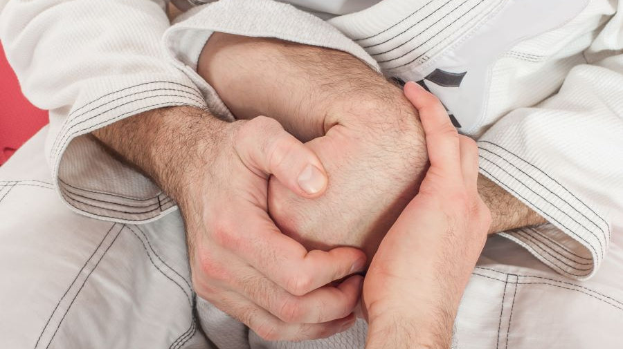 Picture shows a male hand being wrist locked.