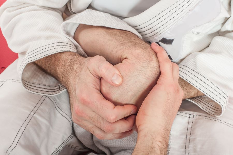 Picture shows a male hand being wrist locked.