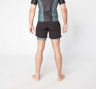 Man in sports shorts and tee standing