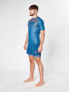 Man in blue athletic shirt and shorts