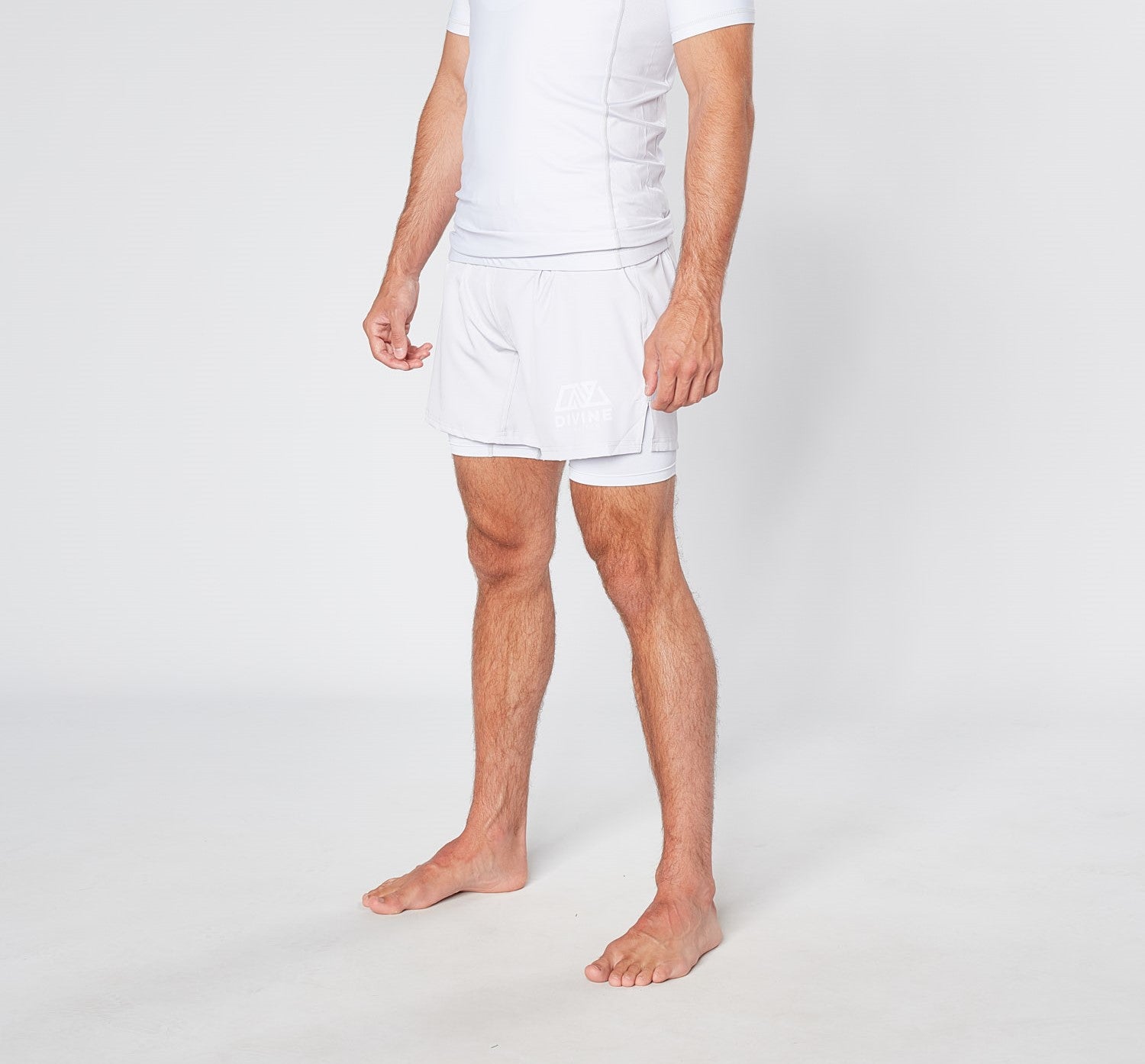 Person in white shorts and T-shirt, standing against a white background.